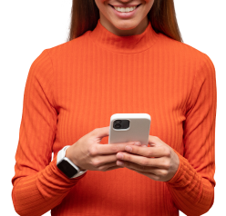 A woman in an orange sweater is smiling while holding a cell phone  | Bill's Auto Electric Repair Inc
