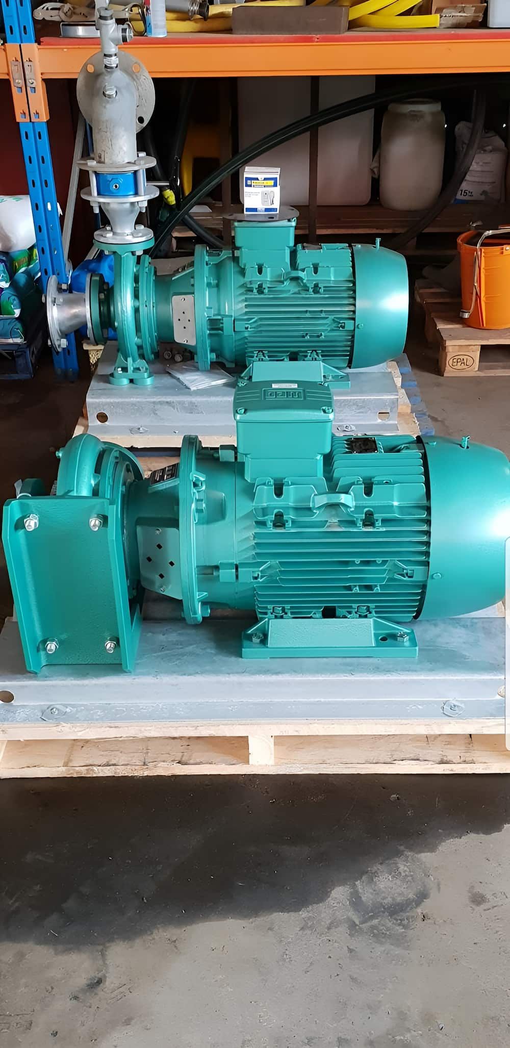 A Couple Of Green Pumps Sitting On Top Of A Wooden Pallet — Manning Valley Pumps And Irrigation In Wingham, NSW