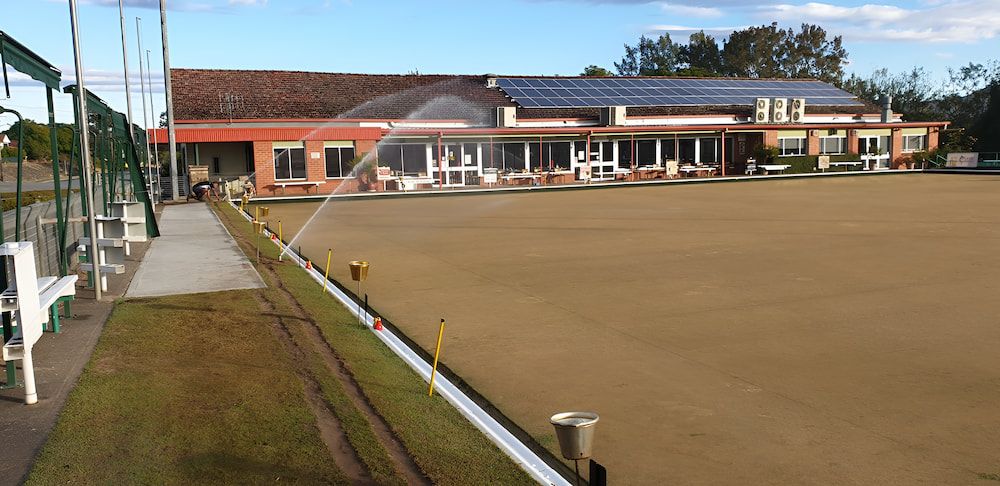A Lawn With A Building In The Background — Manning Valley Pumps And Irrigation In Wingham, NSW