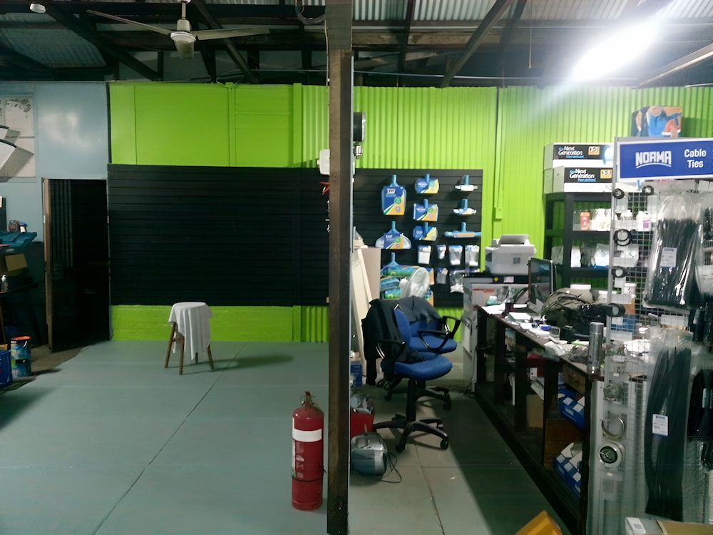 A Store With Green Walls And A Red Fire Extinguisher — Manning Valley Pumps And Irrigation In Nabiac, NSW