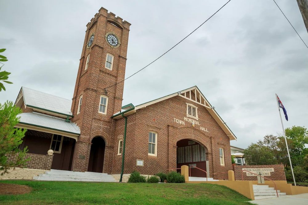 A Large Brick Building With A Clock Tower On Top Of It — Manning Valley Pumps And Irrigation In Wingham, NSW