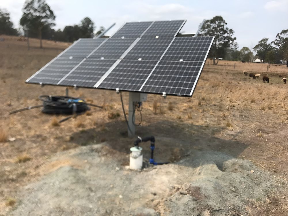 A Solar Panel Is Sitting In The Middle Of A Field — Manning Valley Pumps And Irrigation In Nabiac, NSW