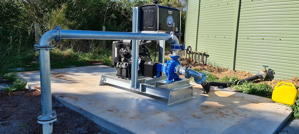 A Water Pump Is Sitting On Top Of A Concrete Platform — Manning Valley Pumps And Irrigation In Wingham, NSW
