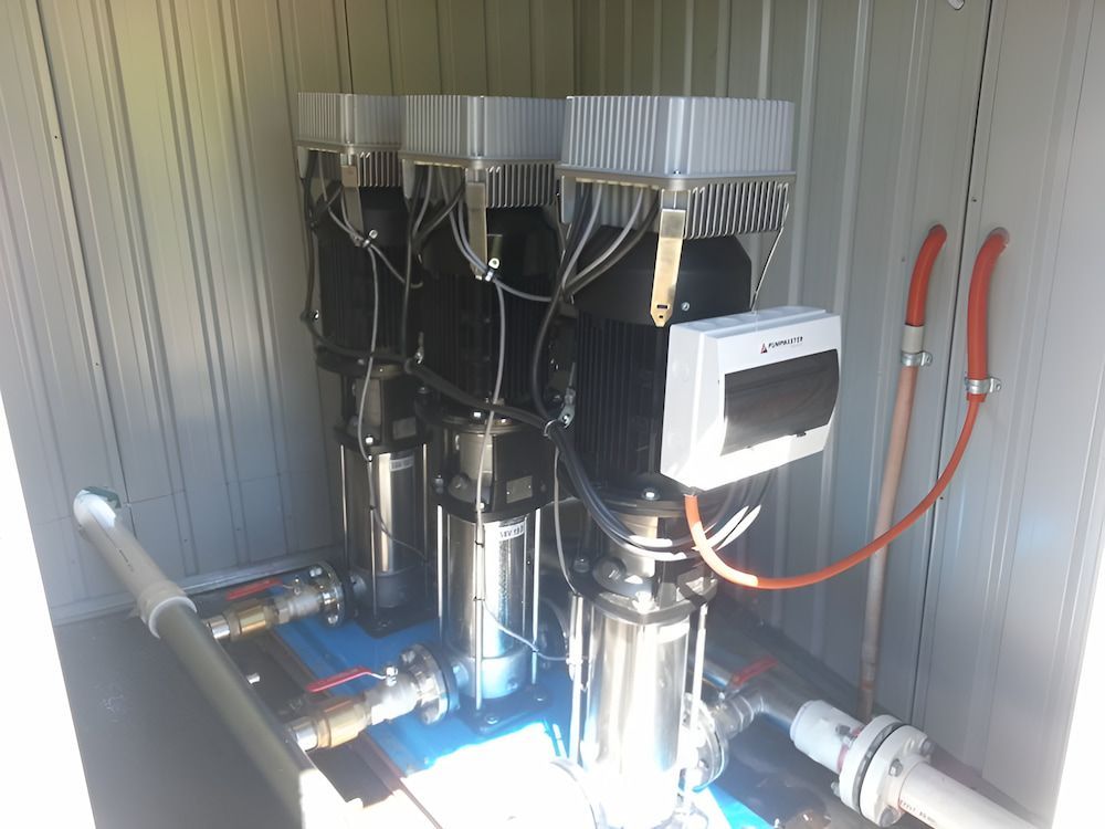 A Row Of Stainless Steel Pumps Are Sitting Inside Of A Building — Manning Valley Pumps And Irrigation In Nabiac, NSW