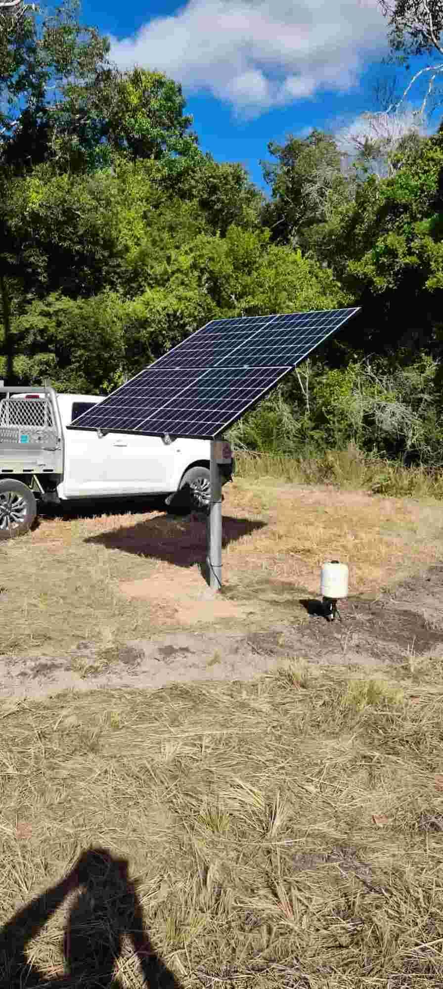 A Solar Panel Is Sitting In The Middle Of A Field Next To A Truck — Manning Valley Pumps And Irrigation In Wingham, NSW