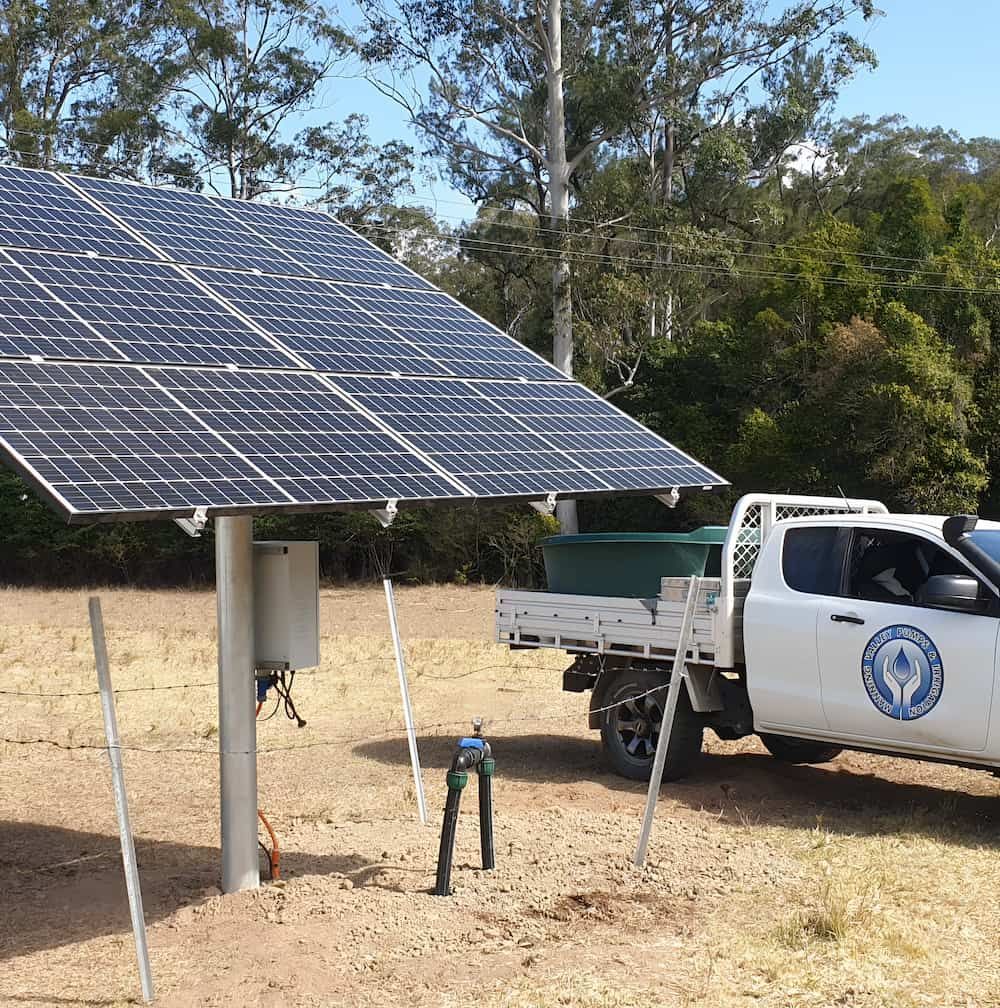A White Truck Is Parked Next To A Solar Panel — Manning Valley Pumps And Irrigation In Wingham, NSW