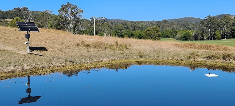 A Pond With A Solar Panel In The Middle Of It — Manning Valley Pumps And Irrigation In Taree, NSW