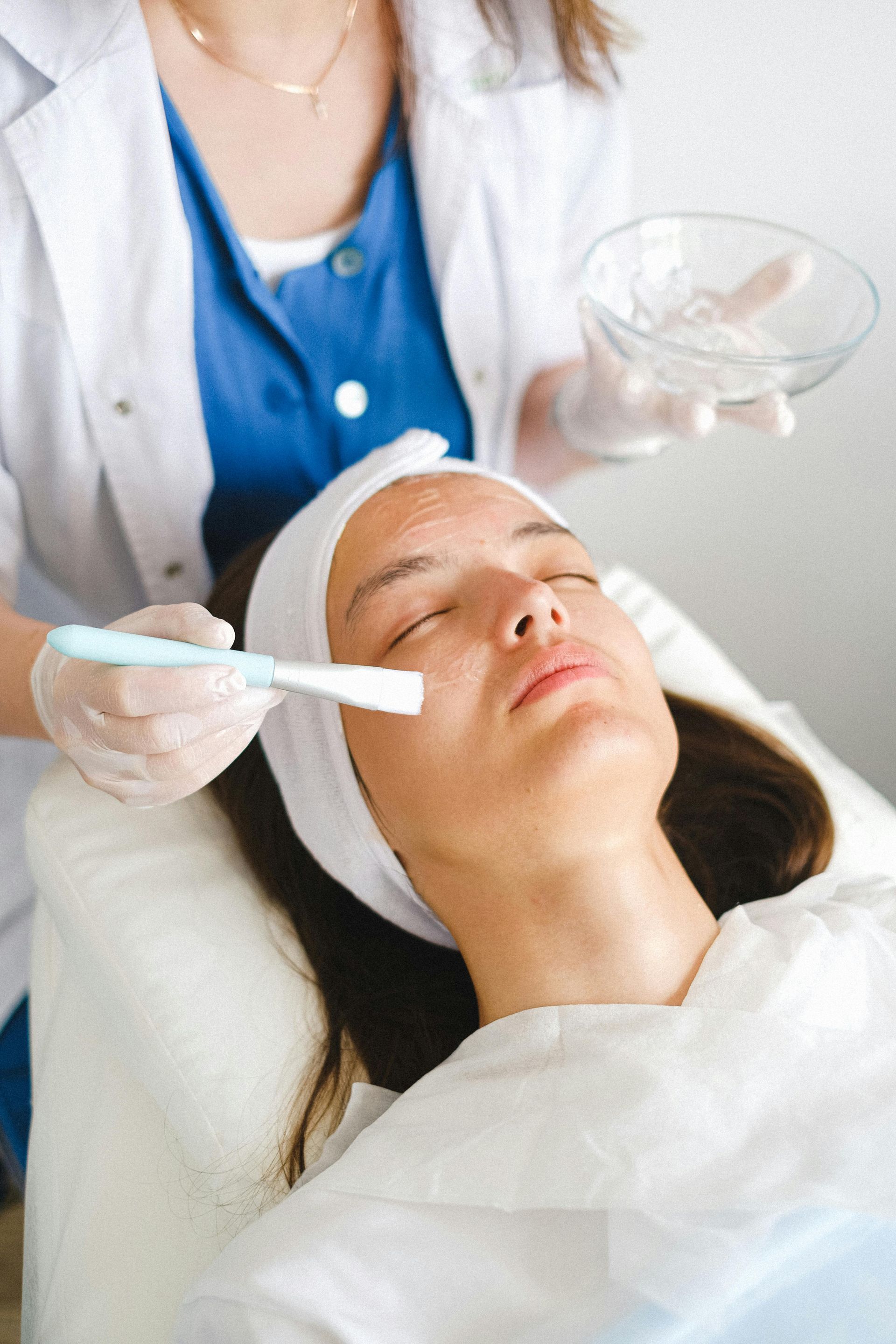 A Woman is Getting a Facial Treatment at a Beauty Salon — Aria Skin & Beauty in Gympie, QLD