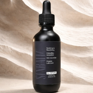 Black dropper bottle on a beige backdrop with soft sculpted shadows