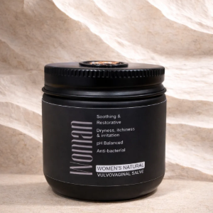 Black cosmetic jar on a stone surface with a beige textured background