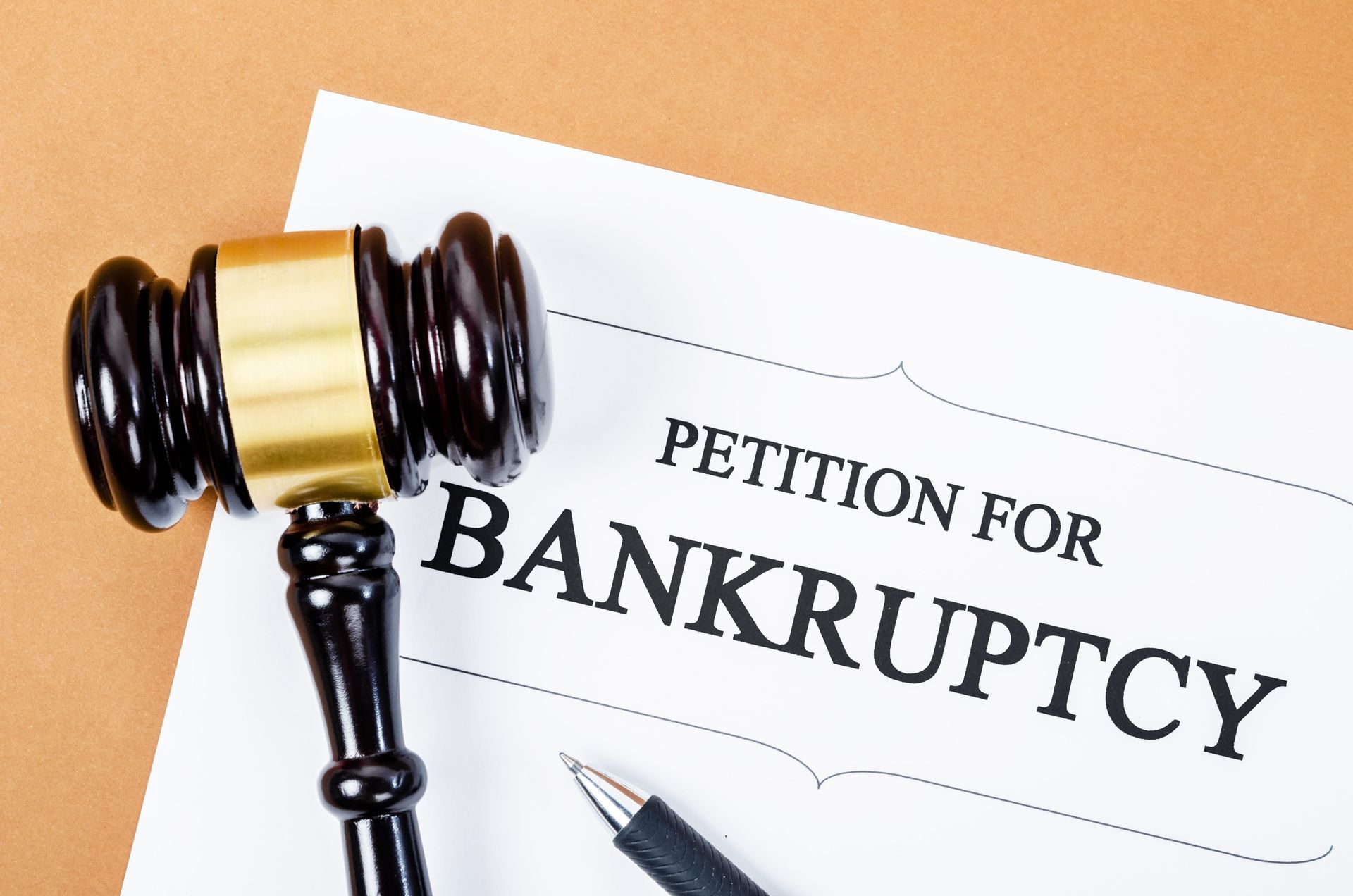 Judge’s gavel over a “Petition for Bankruptcy” document on a desk