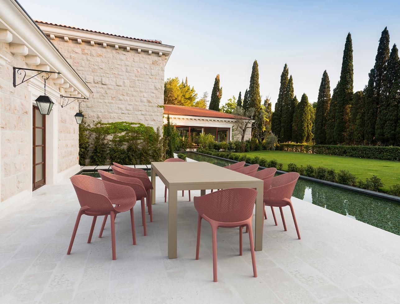 A Patio with A Table and Chairs in Front of A House — Creative Commercial Furniture in Brisbane, QLD