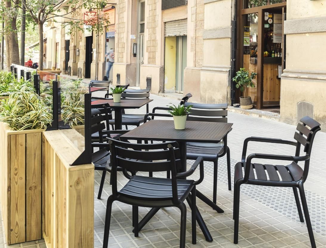 A Row of Tables and Chairs on A Sidewalk in Front of A Building — Creative Commercial Furniture in Gold Coast, QLD
