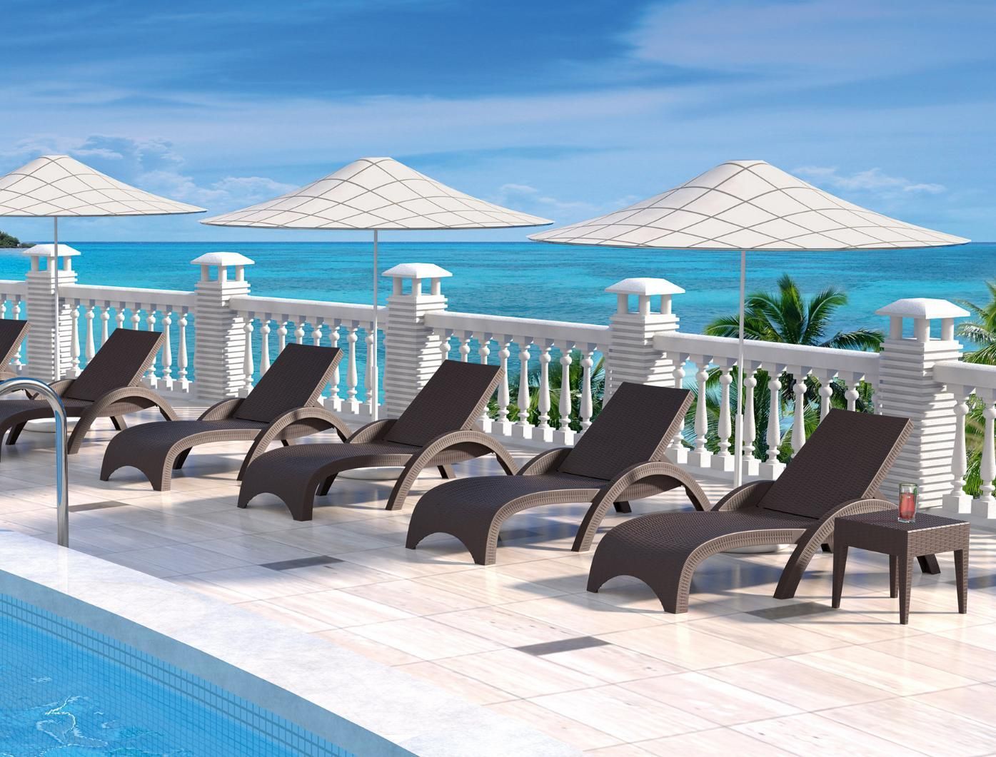 A Row of Lounge Chairs and Umbrellas Next to A Swimming Pool — Creative Commercial Furniture in Cairns, QLD