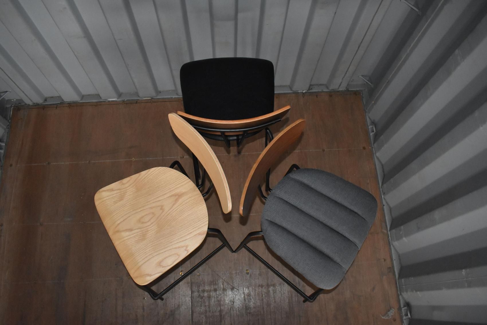 Three Chairs Are Stacked on Top of Each Other on A Wooden Floor — Creative Commercial Furniture in Cairns City, QLD