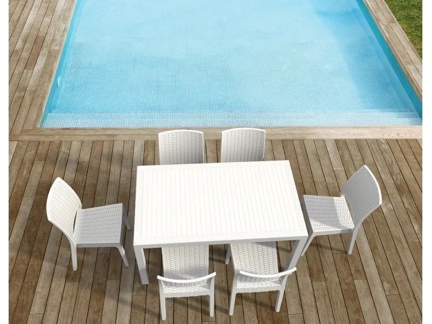 A Table and Chairs on a Wooden Deck Next to a Swimming Pool — Creative Commercial Furniture in Cairns City, QLD 