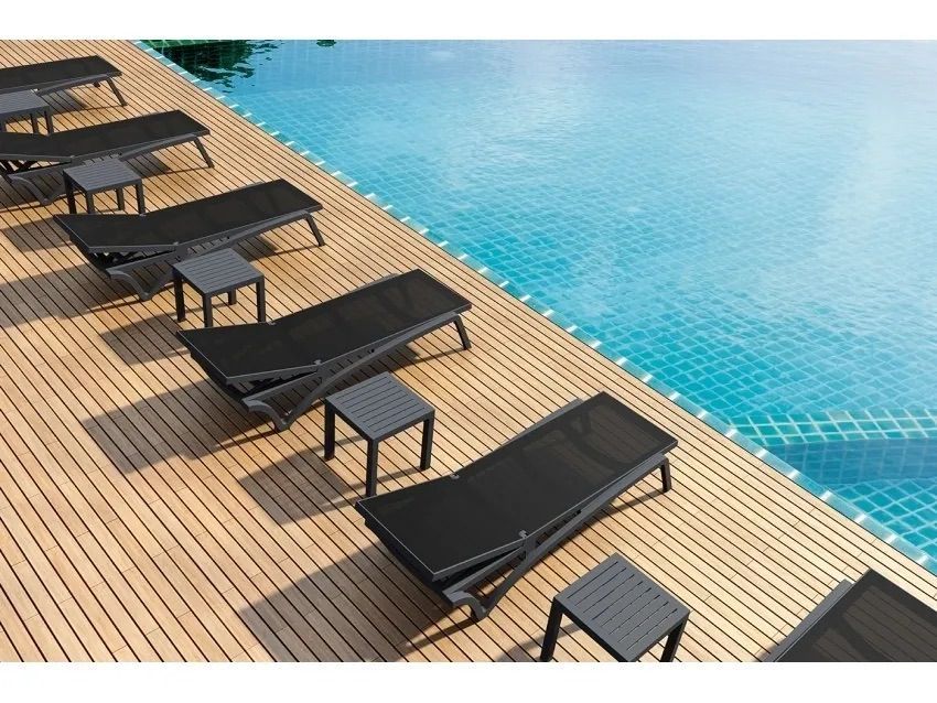 A Row of Lounge Chairs and Tables Next to a Swimming Pool — Creative Commercial Furniture in Cairns City, QLD 