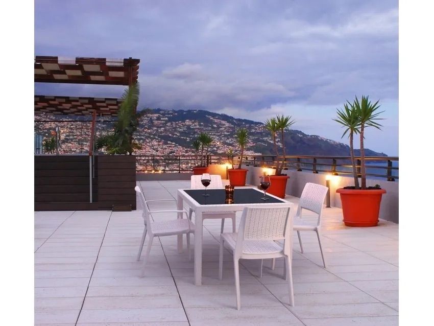 A Table and Chairs on a Rooftop With Mountains in the Background — Creative Commercial Furniture in Cairns City, QLD 
