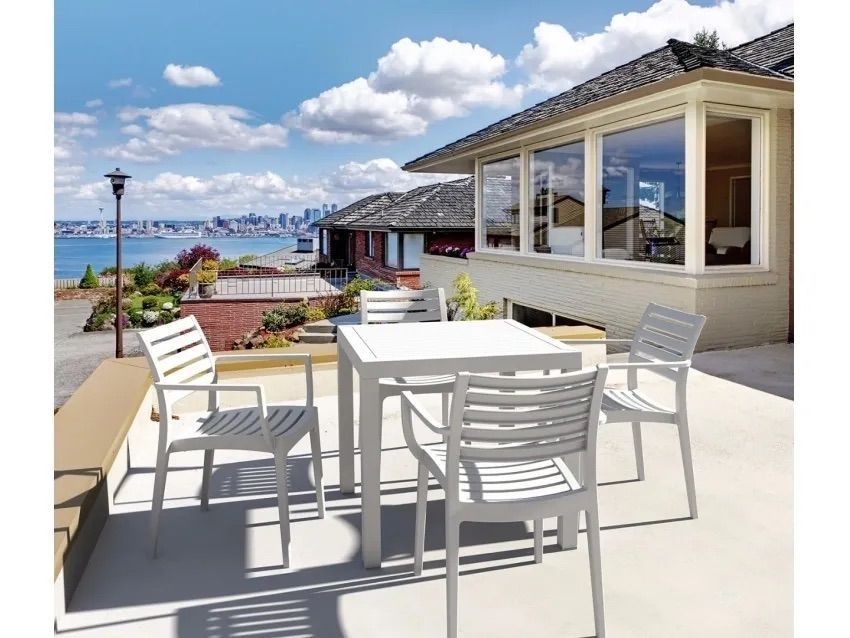 A Patio With a Table and Chairs in Front of a House — Creative Commercial Furniture in Cairns City, QLD 