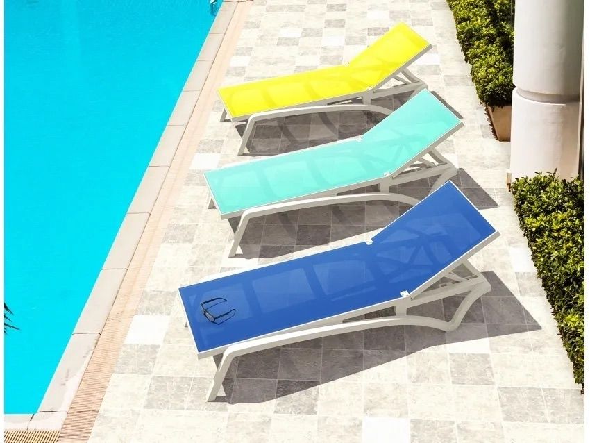 A Row of Colorful Lounge Chairs Next to a Pool — Creative Commercial Furniture in Cairns City, QLD 