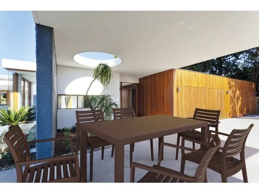 A Patio With a Table and Chairs in Front of a House — Creative Commercial Furniture in Cairns City, QLD 