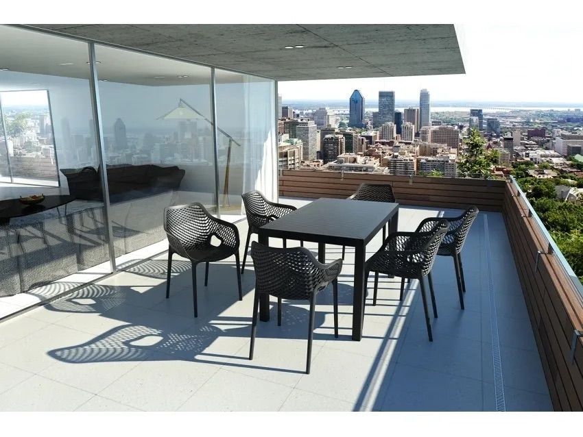 A Balcony With a Table and Chairs Overlooking a City — Creative Commercial Furniture in Cairns City, QLD 
