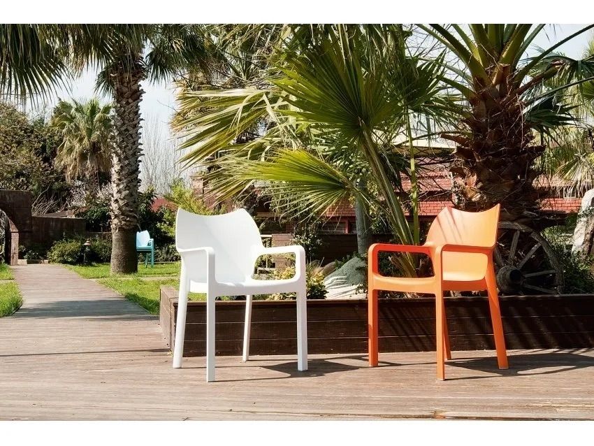 Two Chairs Are Sitting on a Wooden Deck in Front of Palm Trees — Creative Commercial Furniture in Cairns City, QLD 