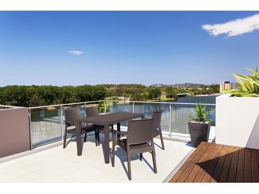 A Table and Chairs on a Balcony Overlooking a Lake — Creative Commercial Furniture in Cairns City, QLD 
