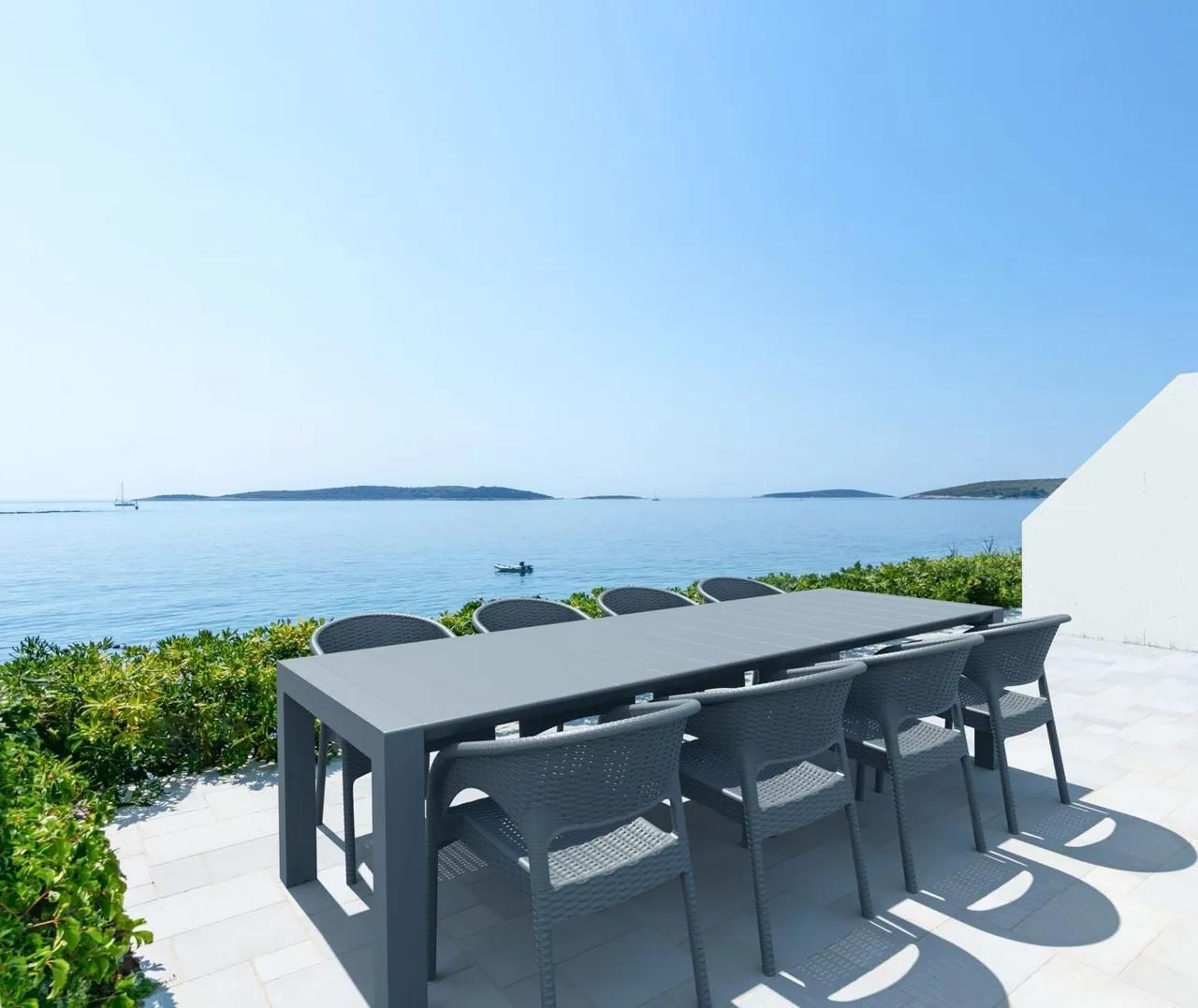 A Table and Chairs on A Patio Overlooking the Ocean — Creative Commercial Furniture in Cairns City, QLD