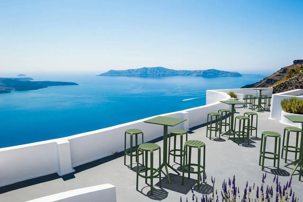 Terrace Cafe With Green Stools and Tables Overlooking the Blue Sea — Creative Commercial Furniture in Cairns City, QLD