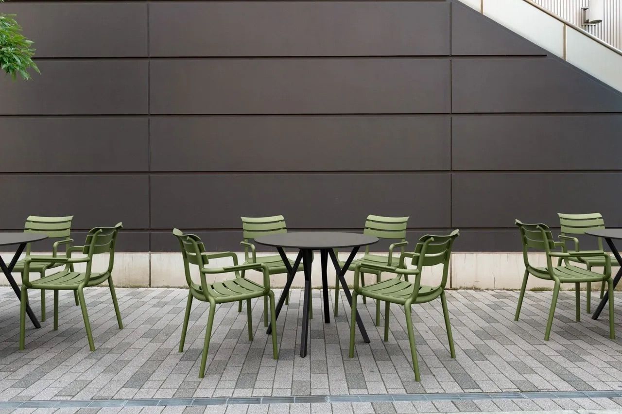 A Row of Green Chairs and Tables in Front of a Building — Creative Commercial Furniture in Cairns City, QLD 