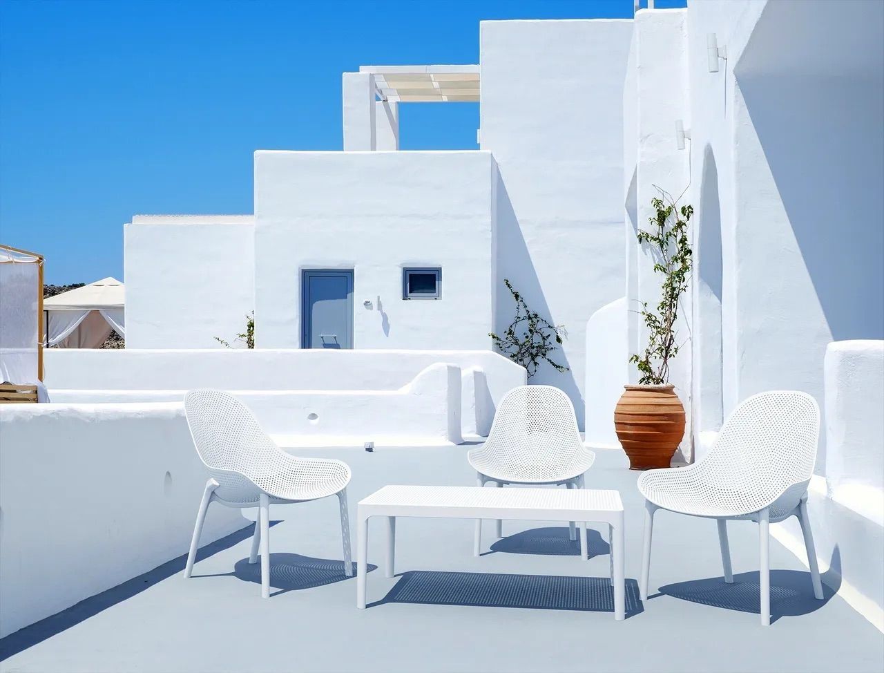 There is a Table and Chairs on the Roof of a White Building — Creative Commercial Furniture in Cairns City, QLD 