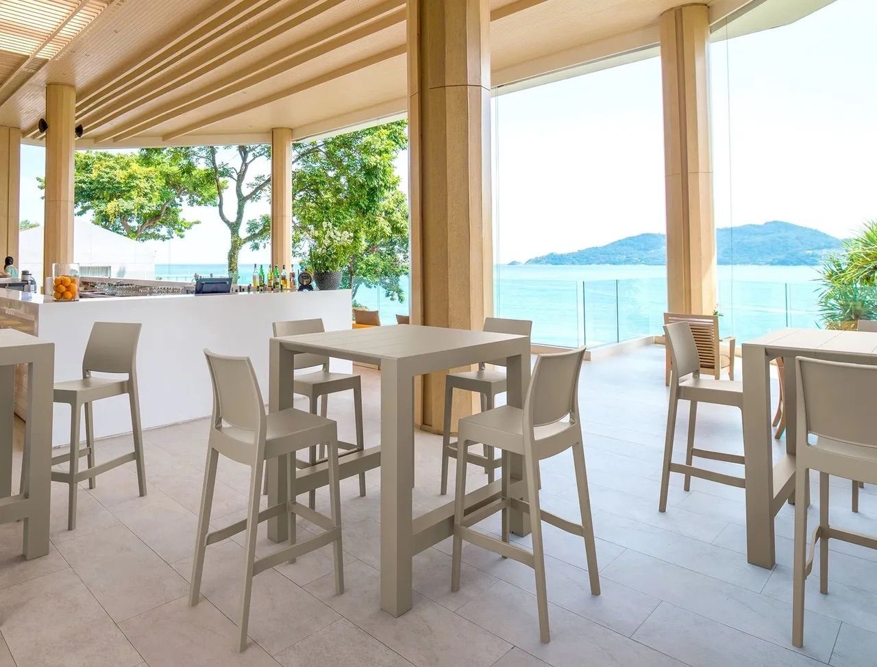 A Restaurant With Tables and Chairs and a View of the Ocean — Creative Commercial Furniture in Cairns City, QLD 