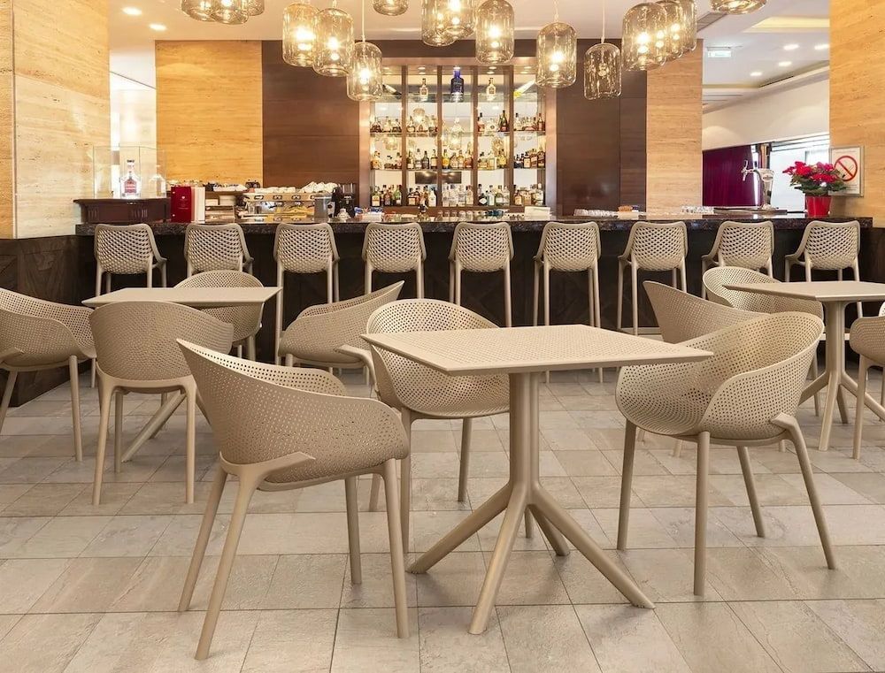 A Restaurant With Tables and Chairs and a Bar in the Background — Creative Commercial Furniture in Cairns City, QLD 