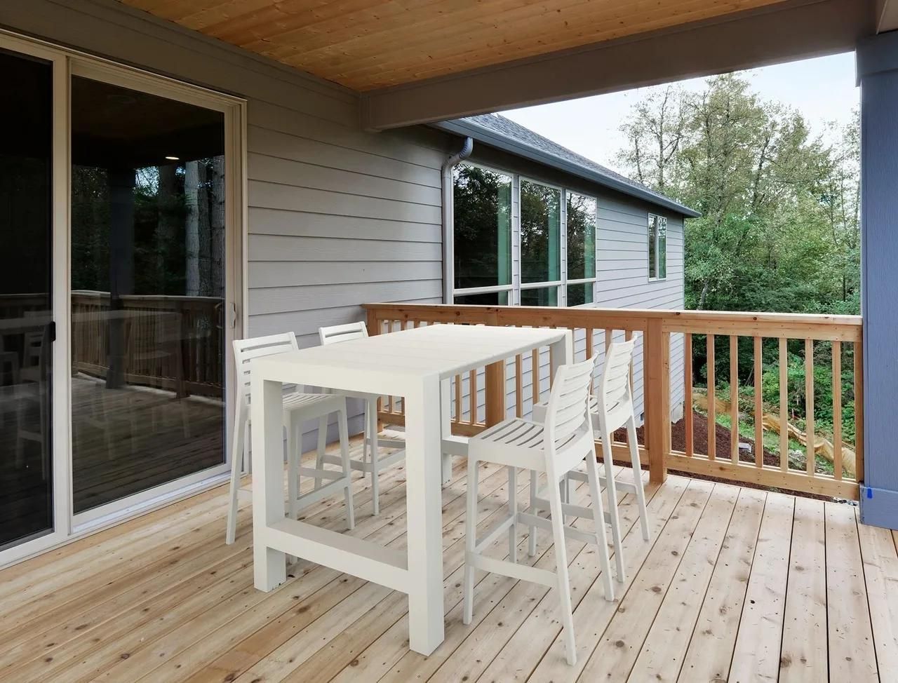 A Wooden Deck with A Table and Chairs on It — Creative Commercial Furniture in Cairns City, QLD