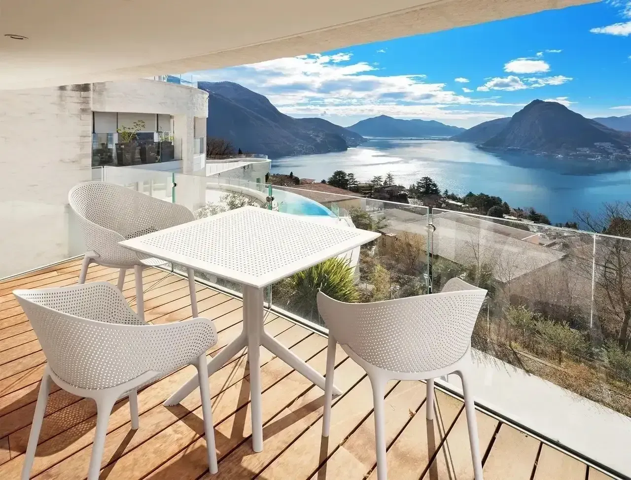 White Patio Set on a Balcony Overlooking a Lake and Mountains — Creative Commercial Furniture in Mackay, QLD