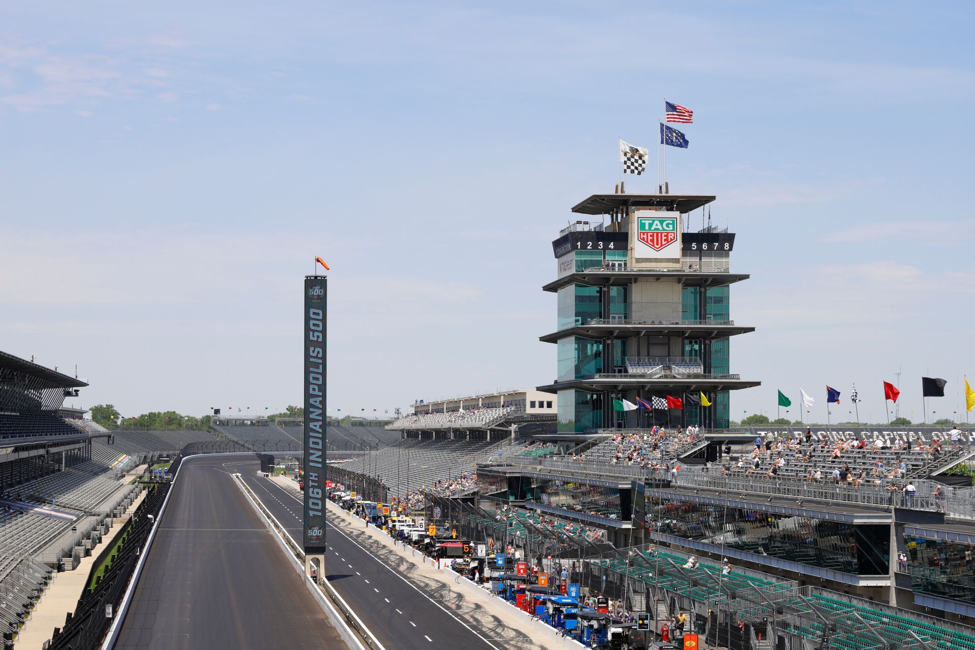 The Indianapolis Motor Speedway racetrack with its iconic pagoda-style control tower on a clear, sunny day.