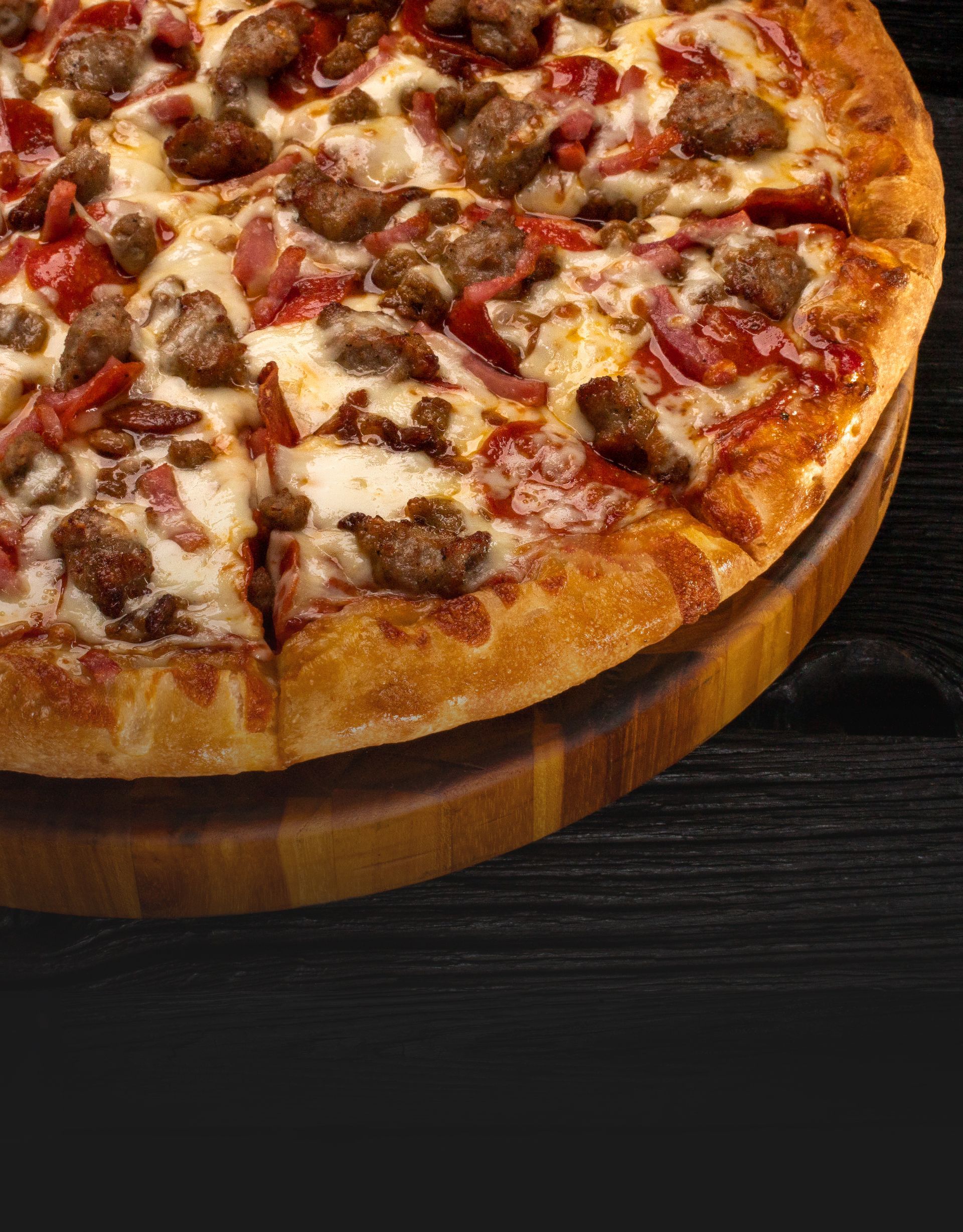 Close up of an all meat pizza with pepperonis and sausage