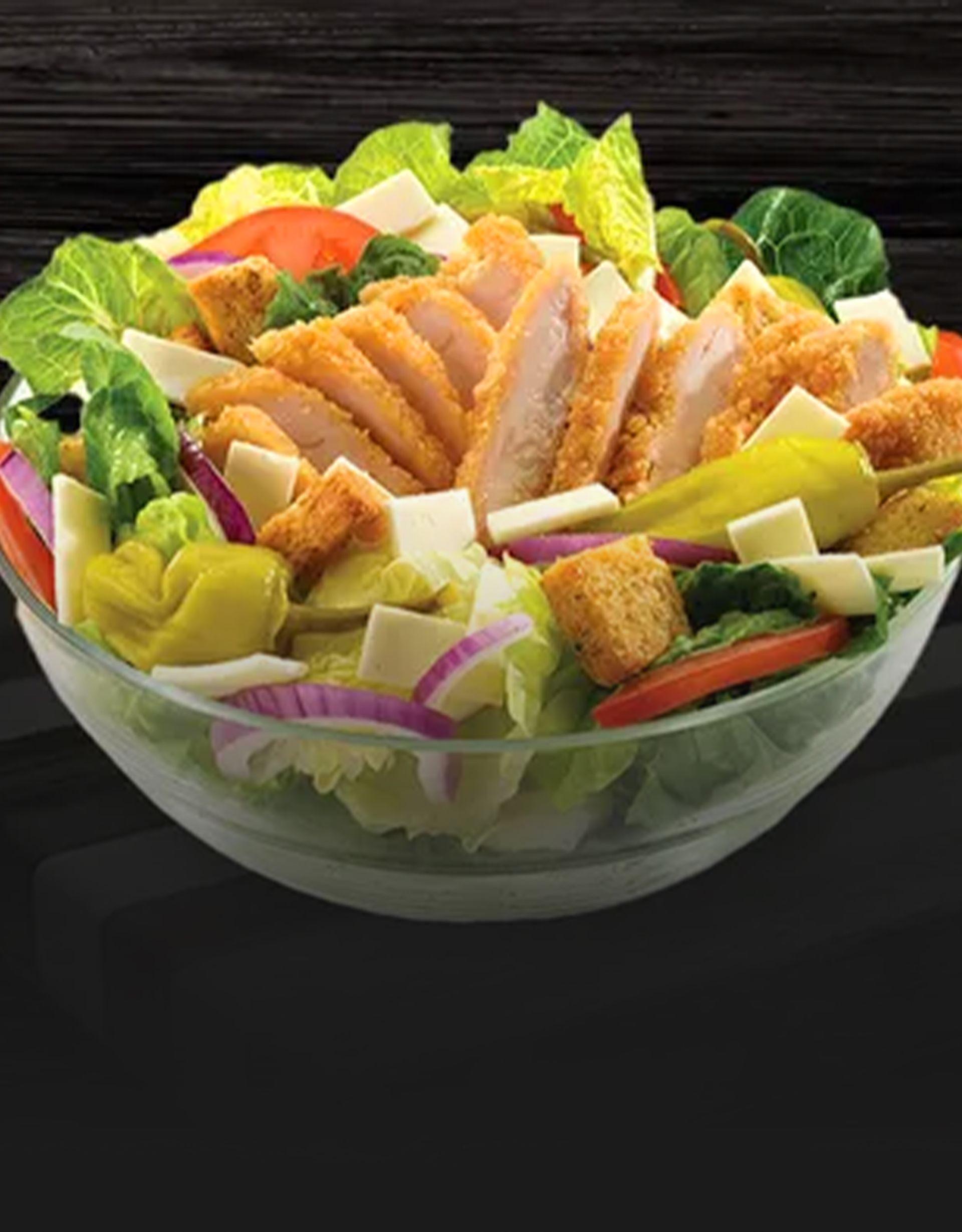Close-up of a fresh Caesar salad topped with croutons and shredded Parmesan cheese
