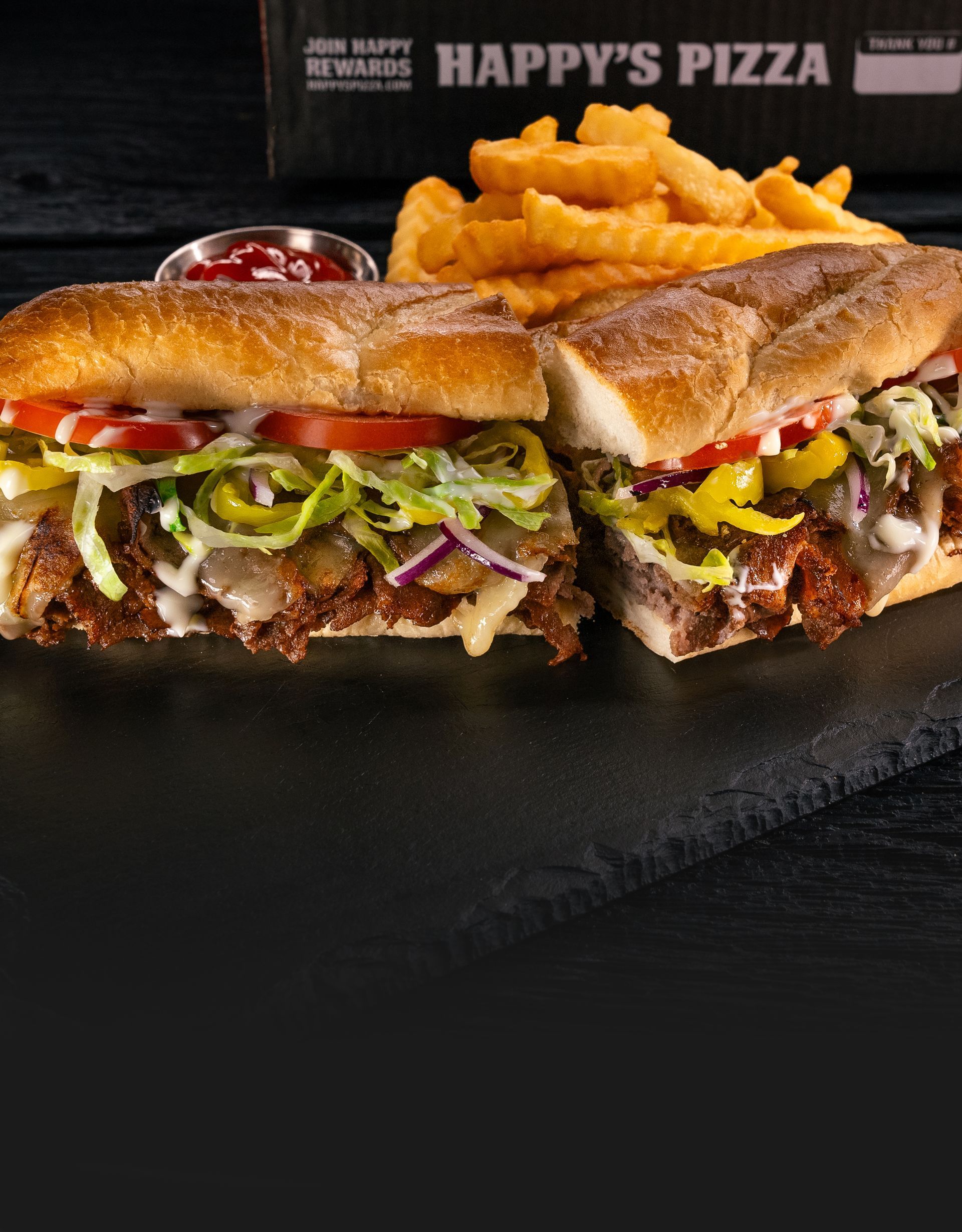 Steak Sub: Sliced steak, crisp lettuce, juicy tomatoes, and tangy peppers in a toasted bun.