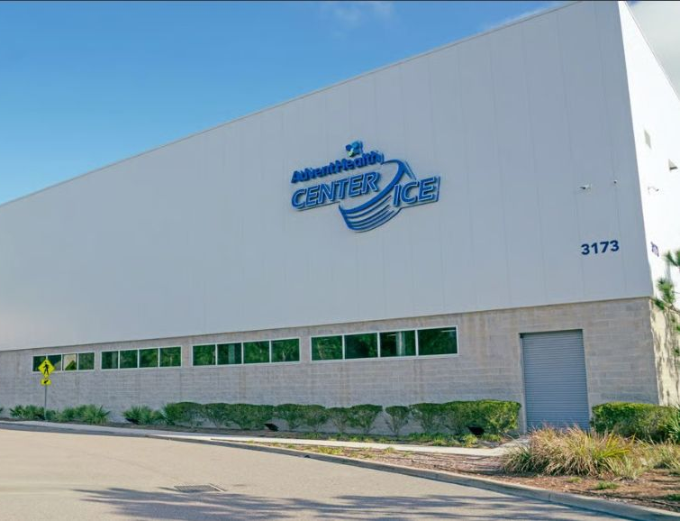 Ice center building exterior with blue logo, green windows, and address 3173