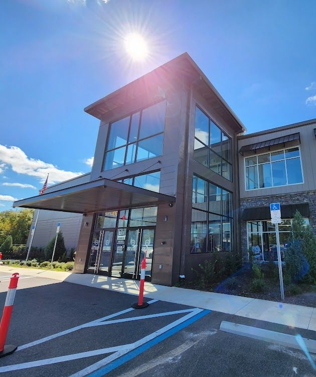 Ice center building exterior with blue logo, green windows, and address 3173