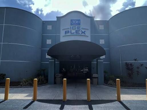 Ice center building exterior with blue logo, green windows, and address 3173