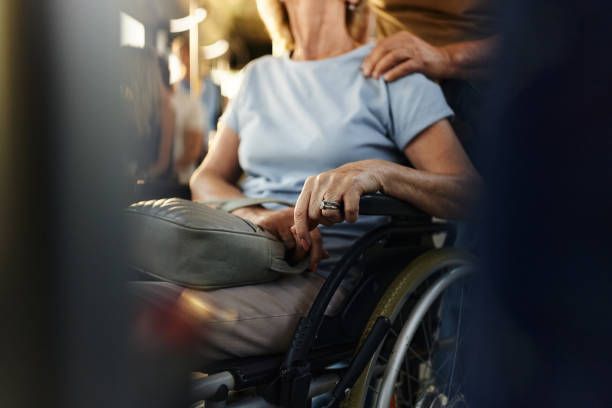 A woman in a wheelchair is sitting on a bus.