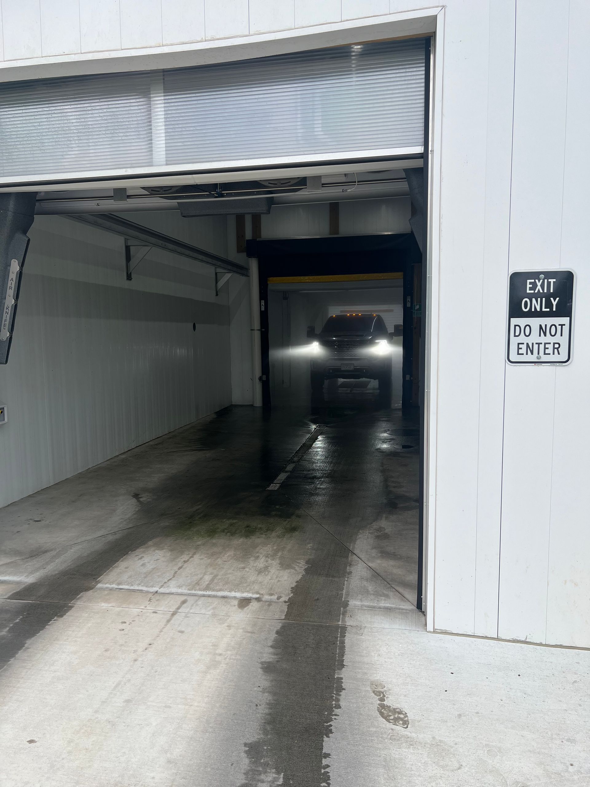 A car is going through a car wash with a sign that says do not enter | Duffy's Auto Service