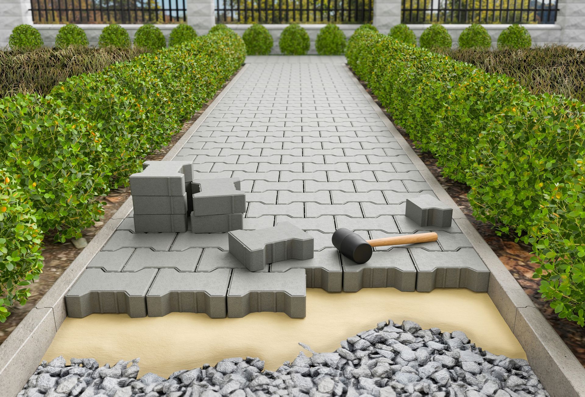 Damaged paved walkway with broken concrete blocks and a fallen hammer between trimmed hedges
