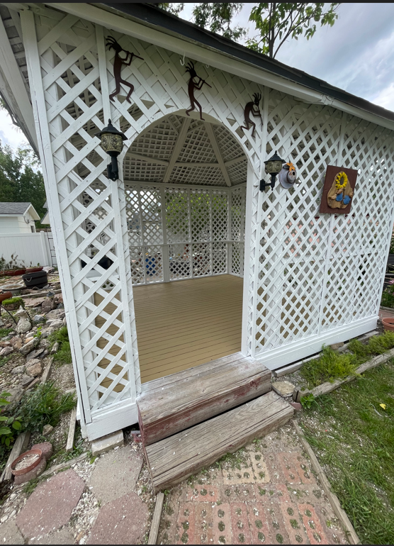 A White Gazebo With Monkeys On The Side Of It