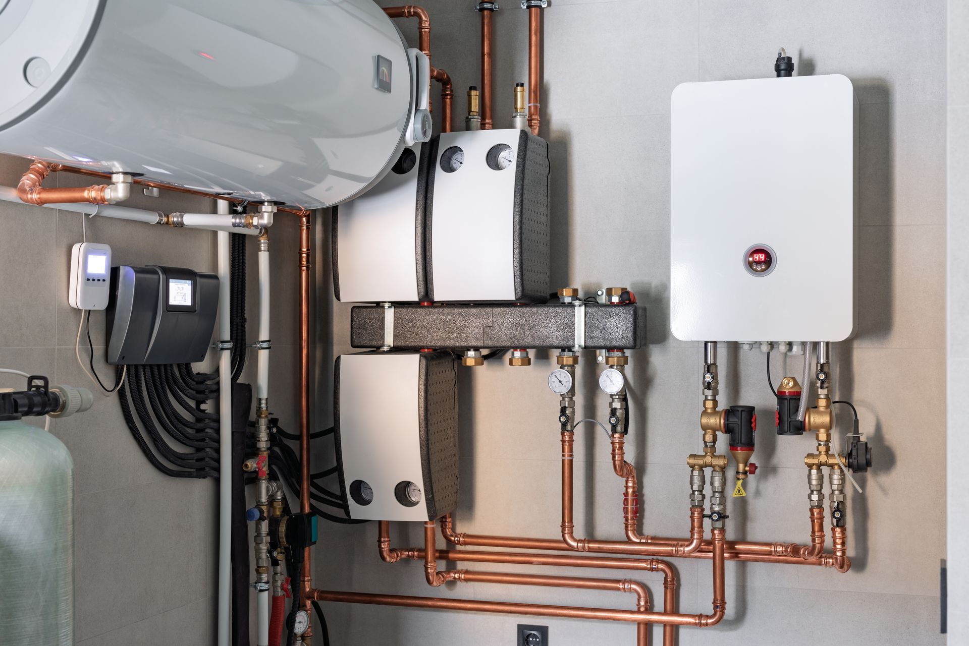 Wall-mounted plumbing and water heater system with copper pipes in a utility room