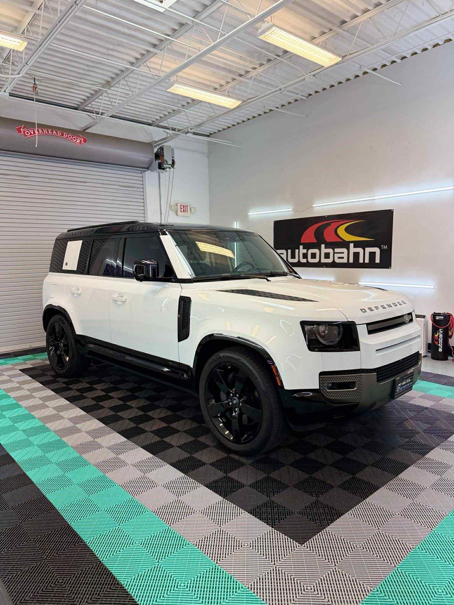 White Land Rover Defender with premium ceramic window tint, professionally installed at GT Tinting 