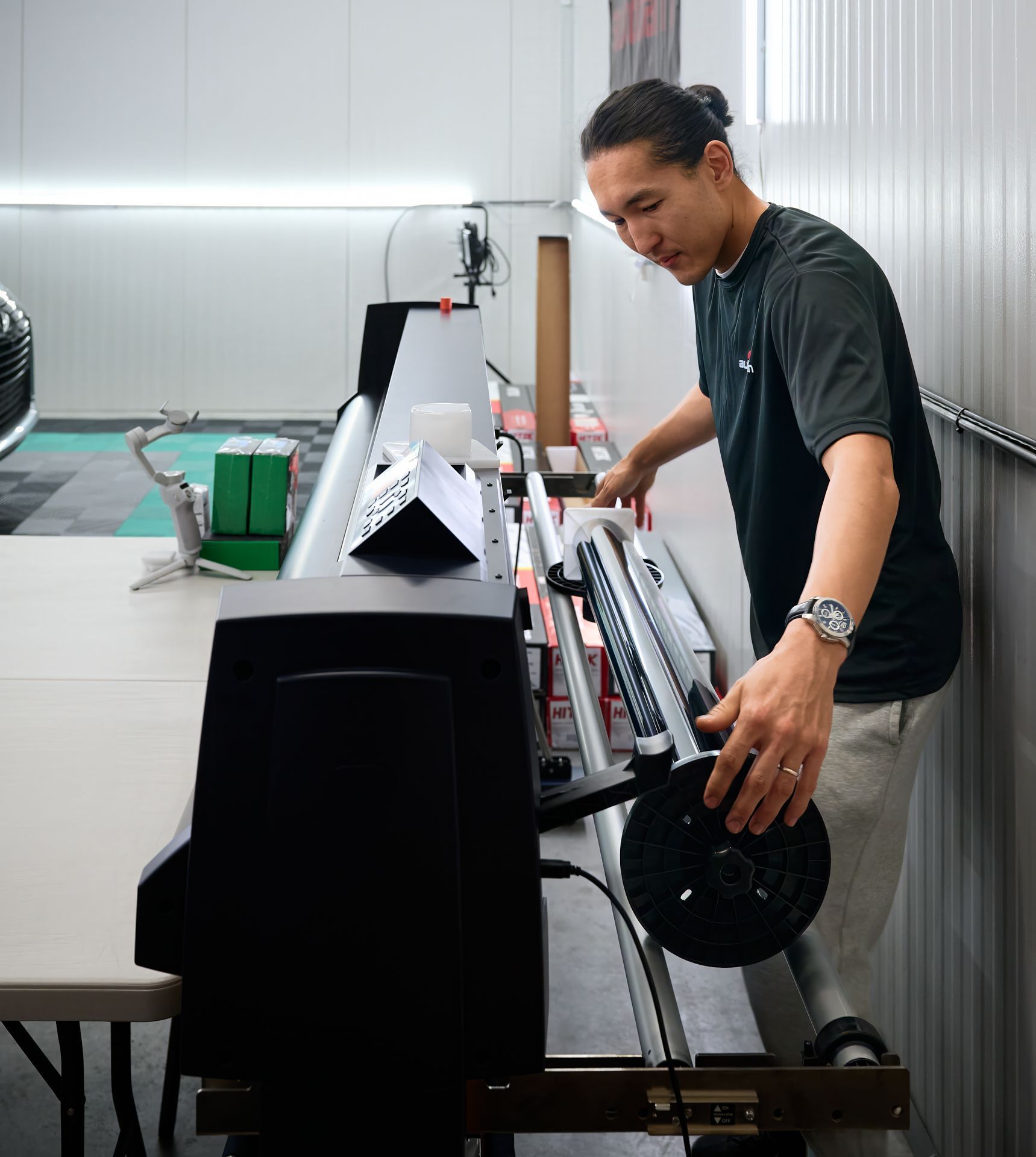 Technician using computer-cut film technology at GT Tinting
